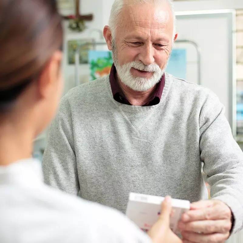 pharmacist holding blister packs of medication